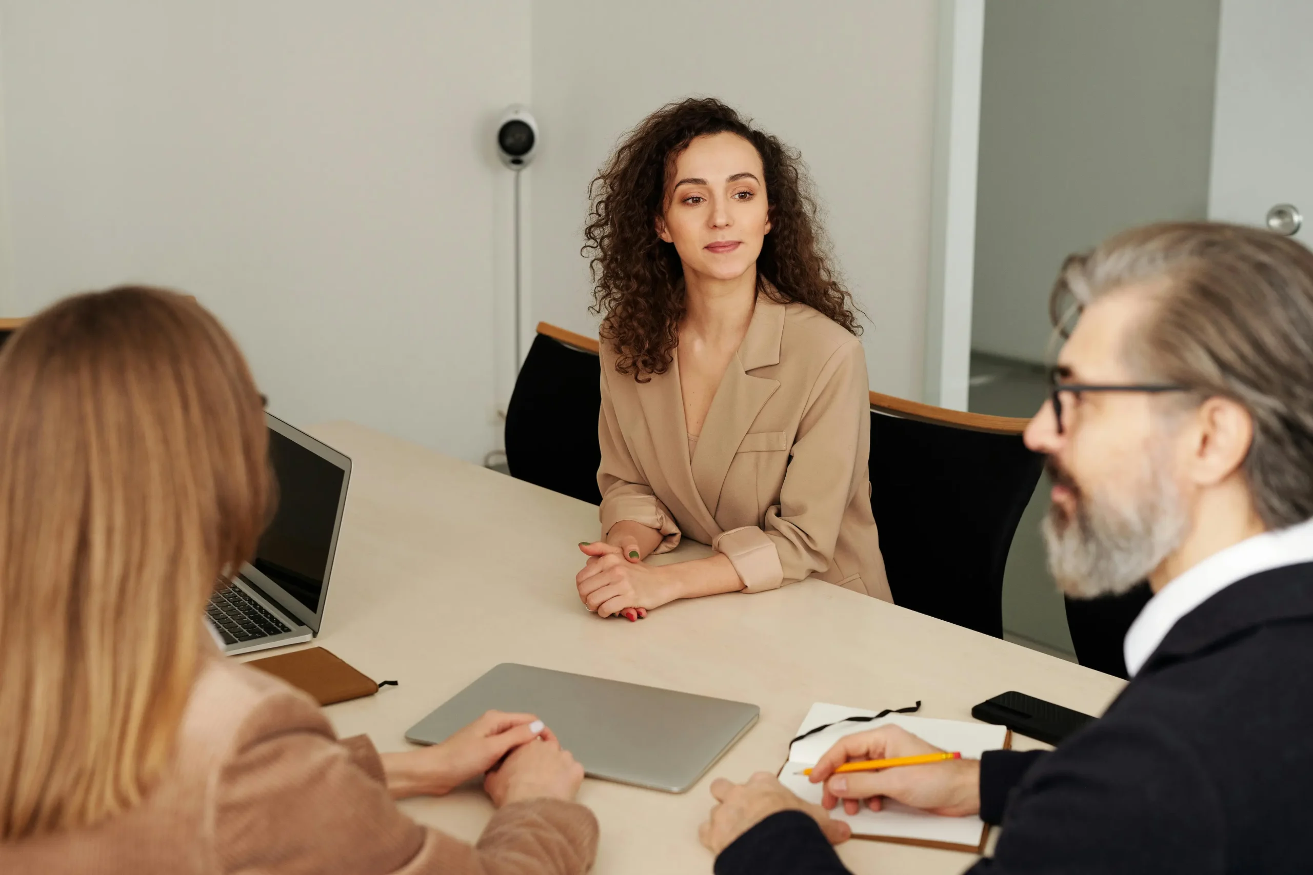 Community association management professionals discussing governance and planning during a board meeting in an office.