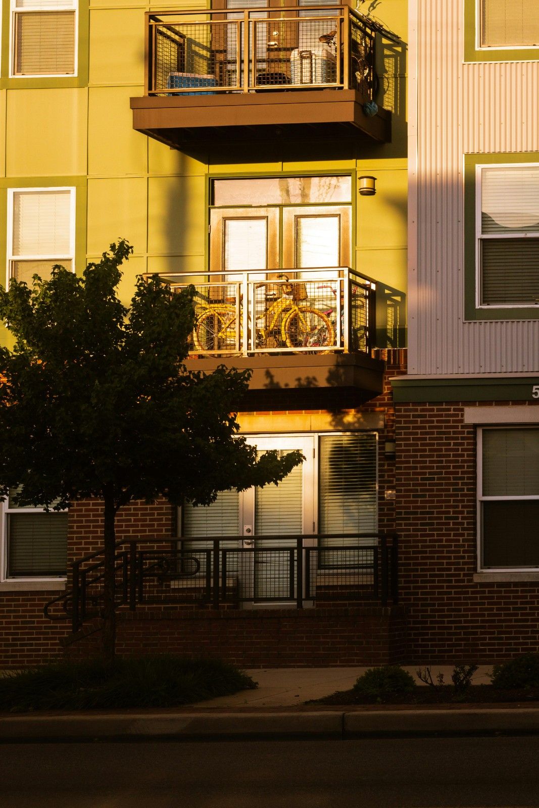 Exterior view of a modern condo building with balconies and entryways, representing condo association management in an urban residential community.