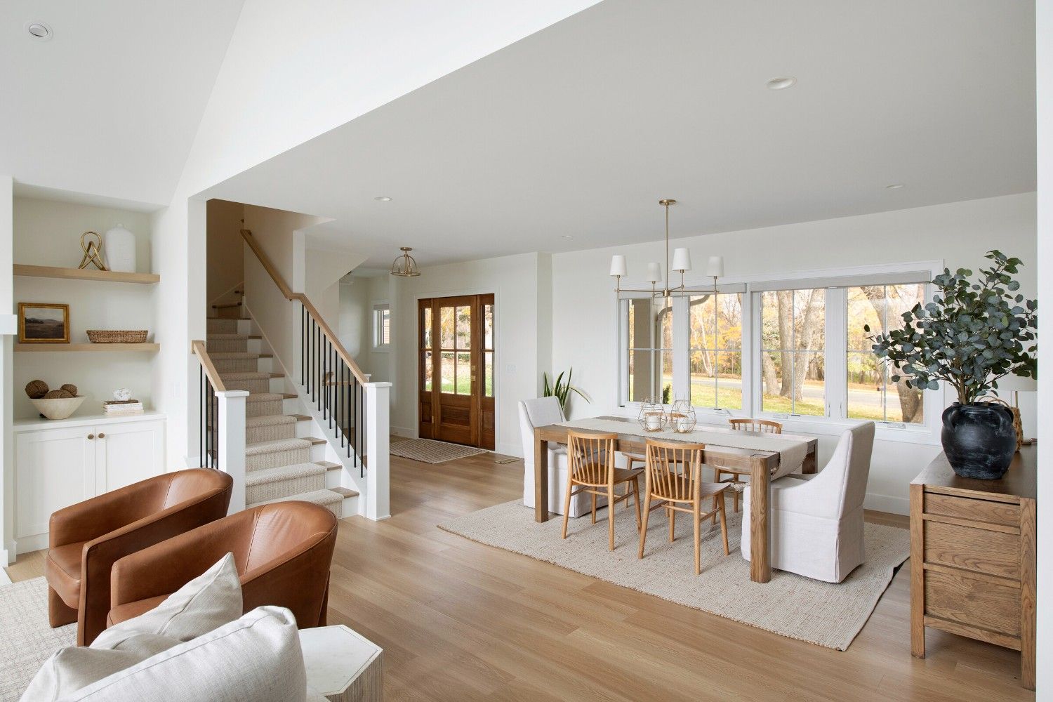 Bright residential interior with dining area, staircase, and modern finishes reflecting well-managed condo association property standards