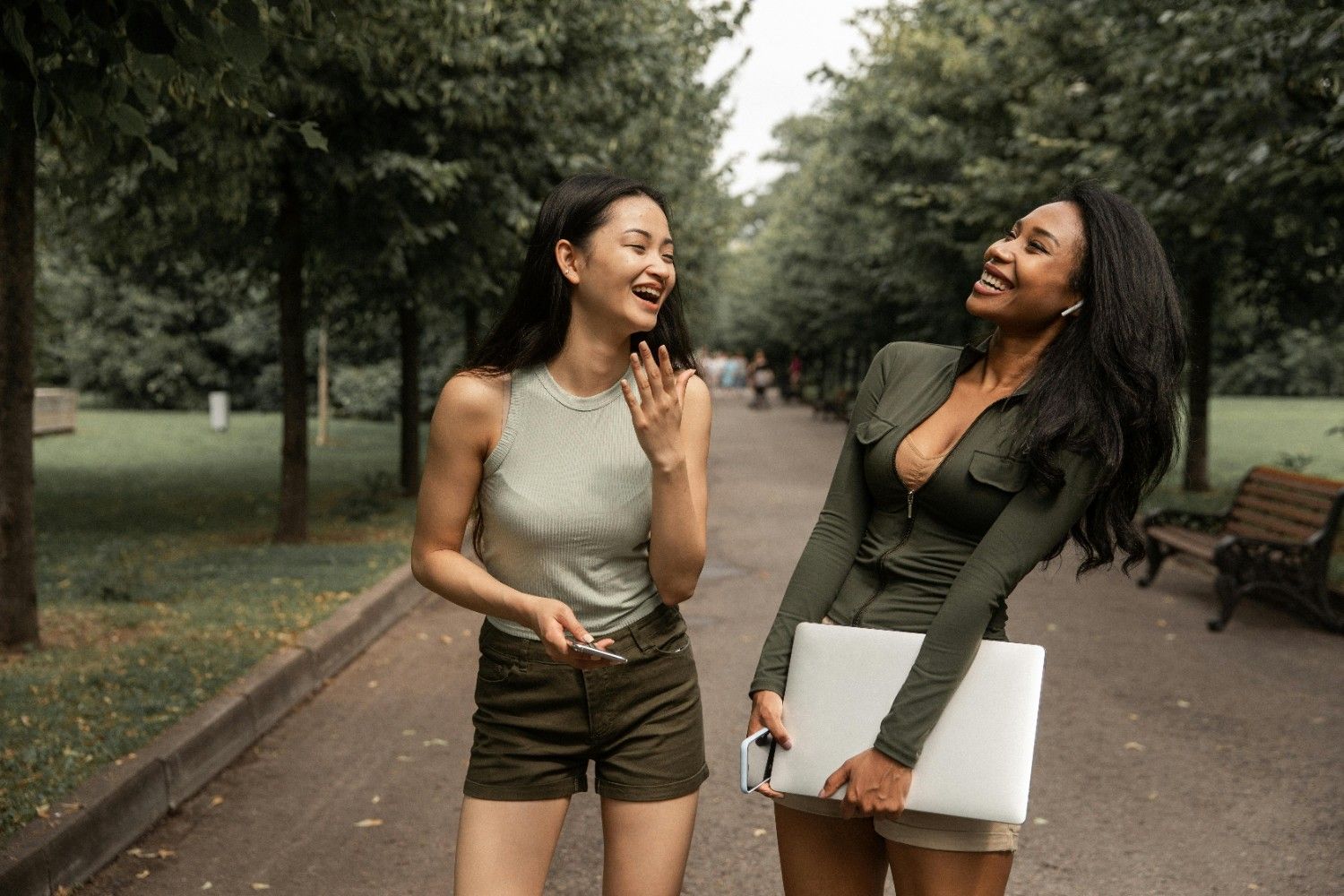 Two residents talking in a shared outdoor walkway, reflecting large-scale community management focused on communication and community connection.