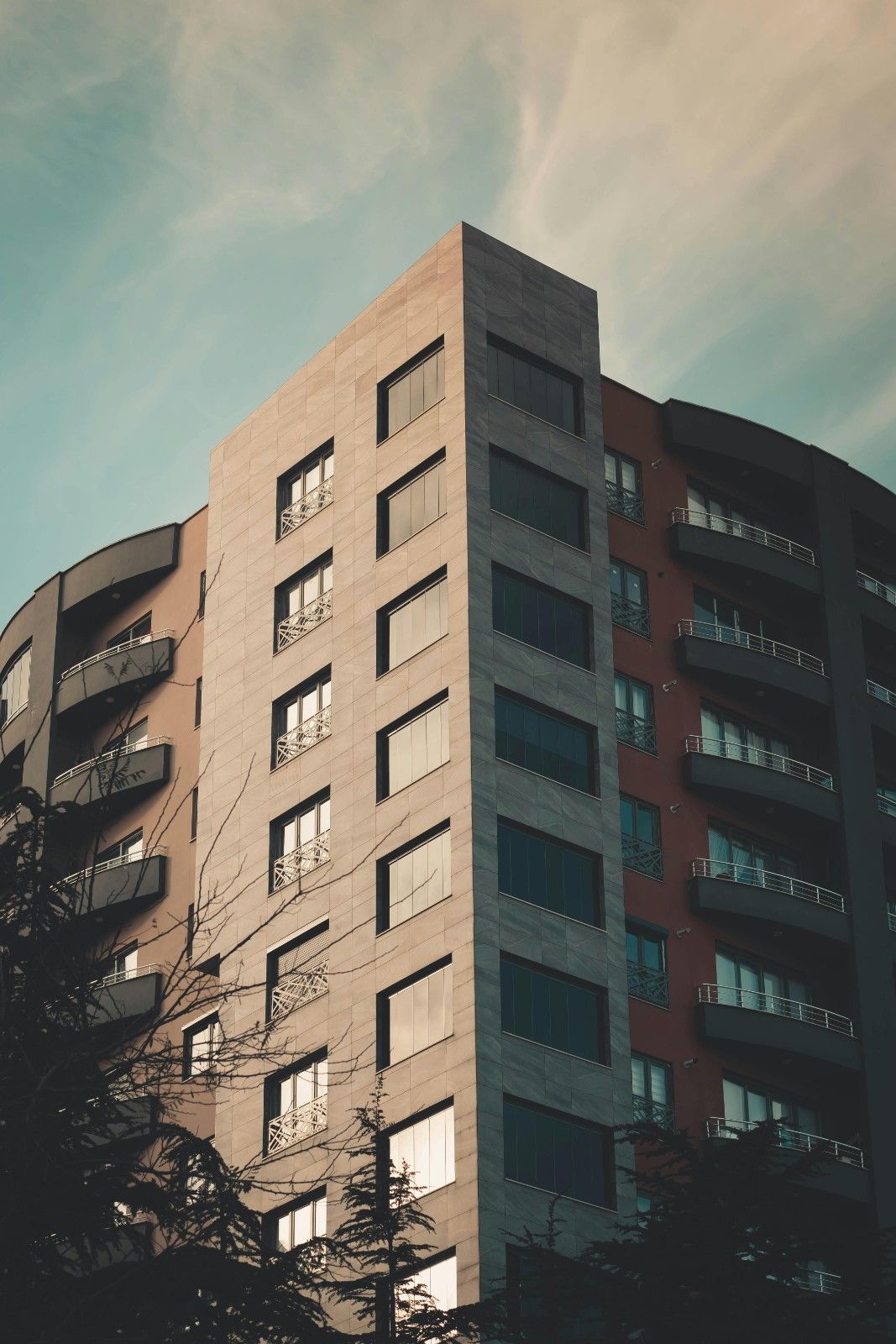 Exterior view of a modern multi-story residential tower, representing large-scale community management in an urban setting.
