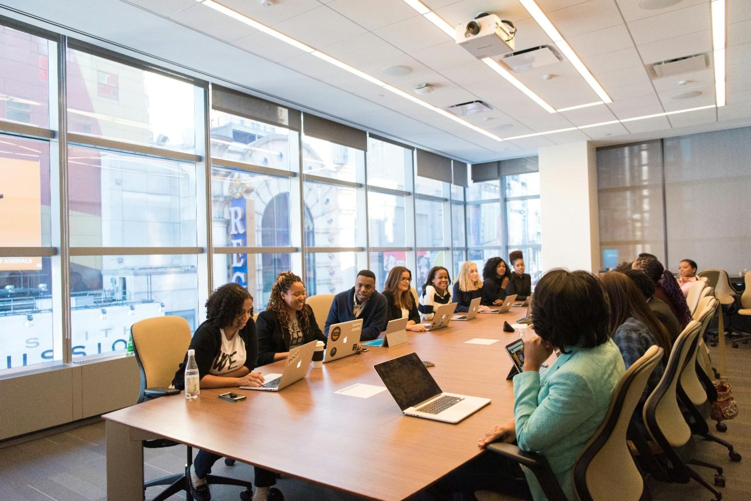 Community management professionals meeting in a conference room, representing HOA and condominium association management services in Dallas-Fort Worth.
