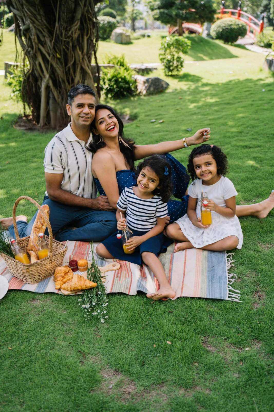 Family enjoying a picnic in a community park surrounded by landscaped green space