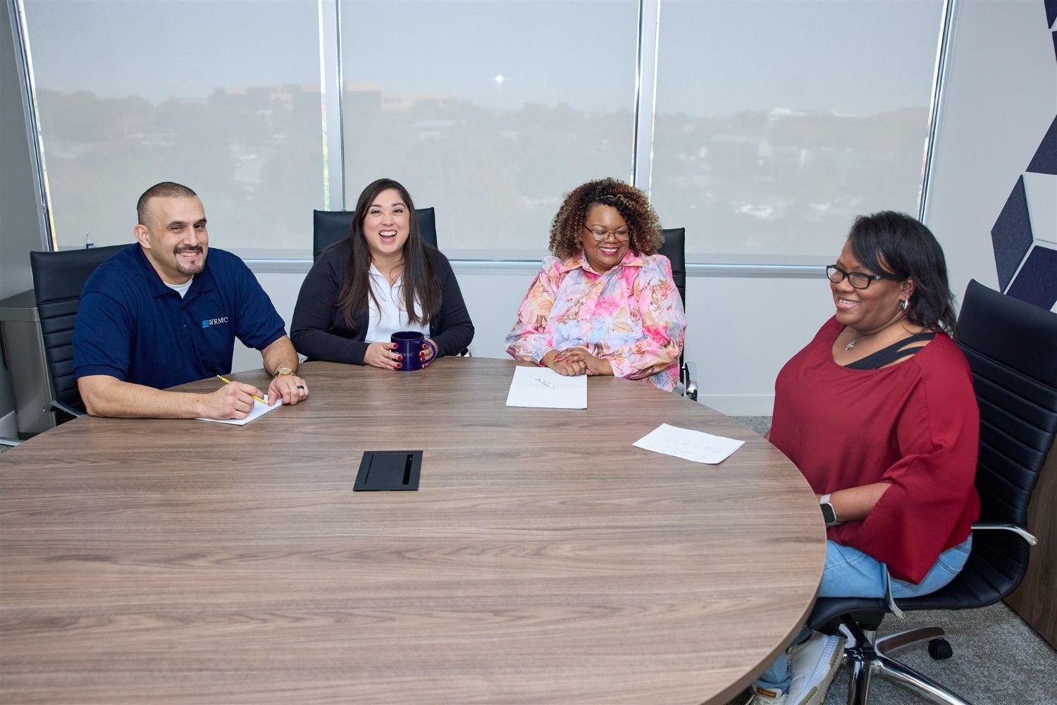 Community association management team meeting to discuss HOA operations and resident services.