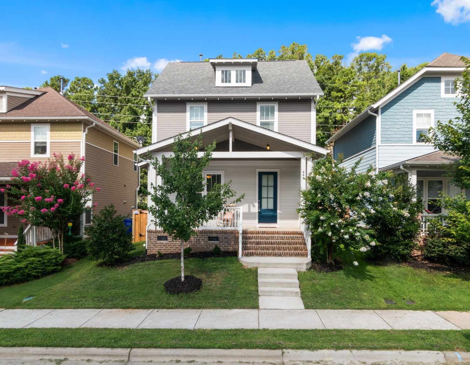 Well-maintained suburban homes with landscaped front yards and sidewalks.